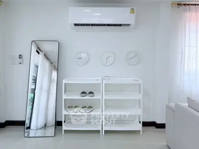 Modern living room with air conditioning, minimalist shelves, and stylish decor.