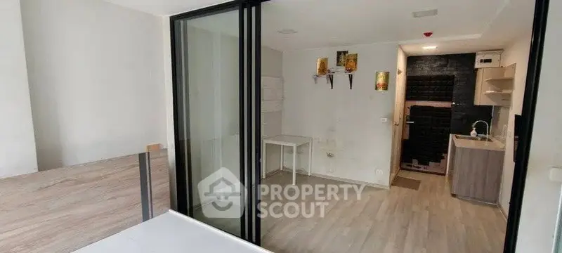 Modern studio apartment with open layout and sleek kitchen design.