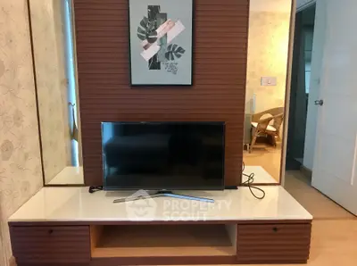 Modern living room with stylish TV stand and wall art, perfect for cozy entertainment evenings.