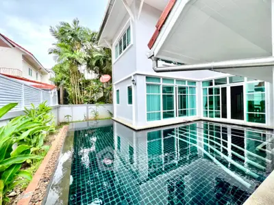 Luxurious home with private pool and lush greenery, perfect for relaxation and entertaining.