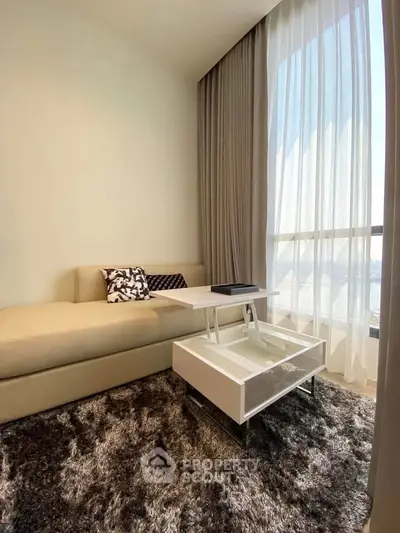 Modern living room with cozy sofa and elegant curtains, perfect for relaxation.