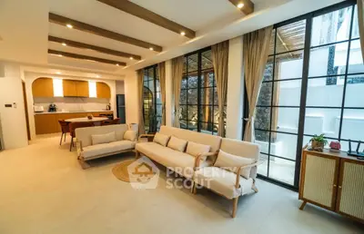 Modern open-layout living room with stylish decor and large windows