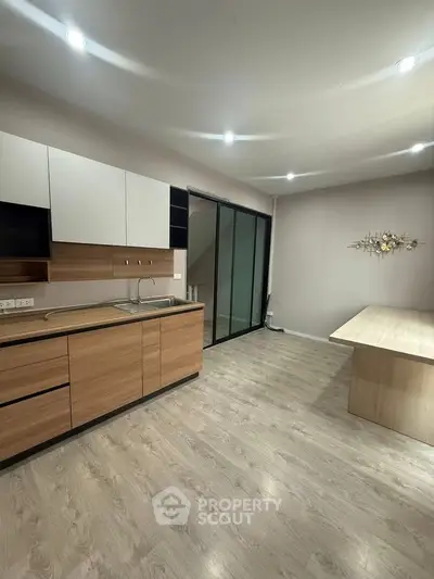 Modern kitchen with sleek wooden cabinetry and open layout design