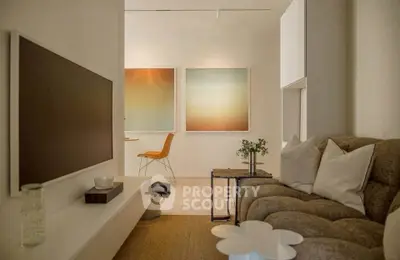 Stylish modern living room with cozy sofa and wall-mounted TV, perfect for relaxation and entertainment.