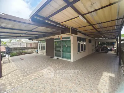 Spacious covered outdoor area with tiled flooring and modern design.