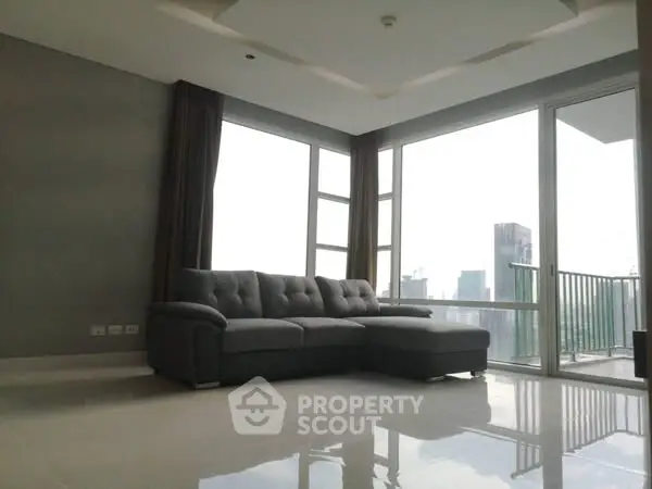 Spacious modern living room with large windows and city view