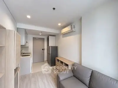 Modern compact living room with integrated kitchen and sleek design