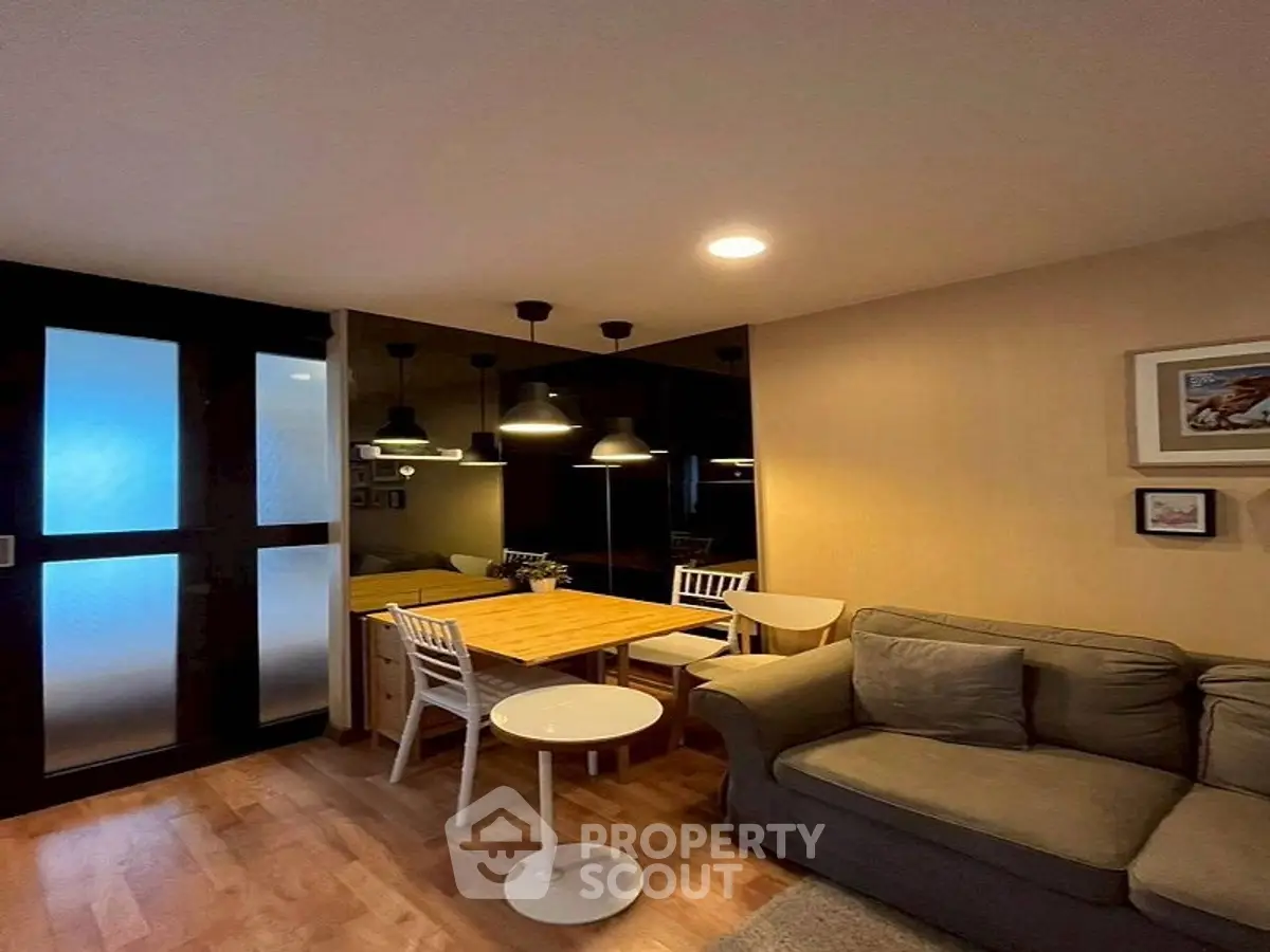 Cozy living room with modern lighting and comfortable seating