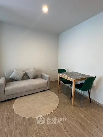 Modern living room with cozy sofa and dining table, ideal for small spaces.