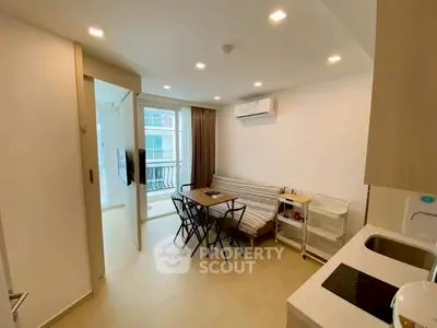 Modern open-layout living room with dining area and balcony access