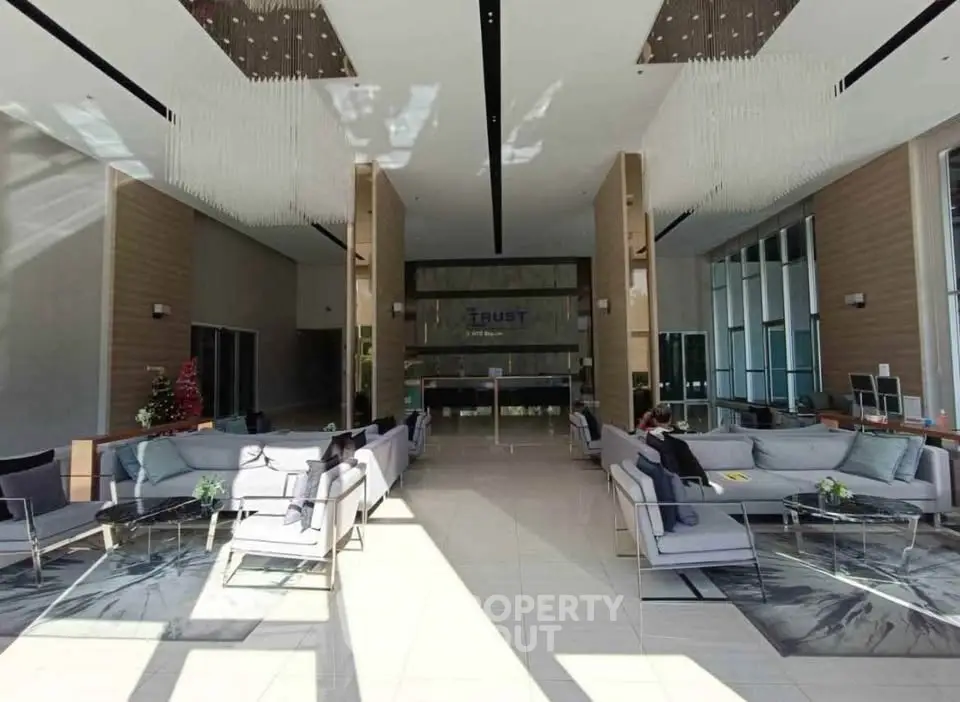 Luxurious modern lobby with elegant seating and high ceilings in a premium real estate property.
