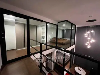 Modern loft-style bedroom with glass walls and stylish lighting