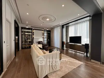 Luxurious living room with elegant decor and large windows offering natural light.