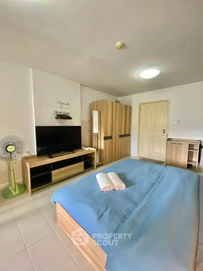 Spacious bedroom with modern furniture and cozy ambiance, perfect for relaxation.