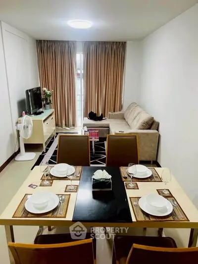 Modern living room with dining area, cozy sofa, and elegant decor in a stylish apartment.