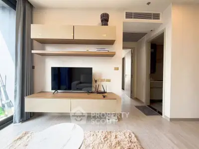 Modern living room with sleek TV unit and stylish decor in a contemporary apartment.