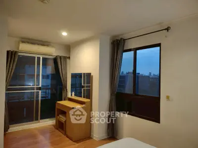 Cozy bedroom with city view and elegant wooden furniture