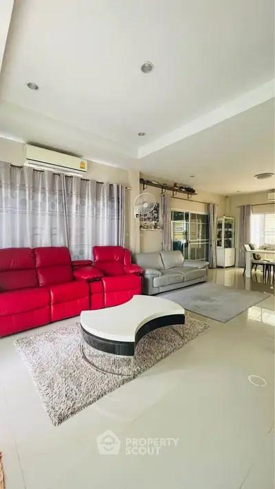 Spacious living room with modern furniture and large windows for natural light.