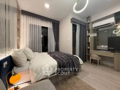 Modern bedroom with stylish decor and ambient lighting in a contemporary apartment.