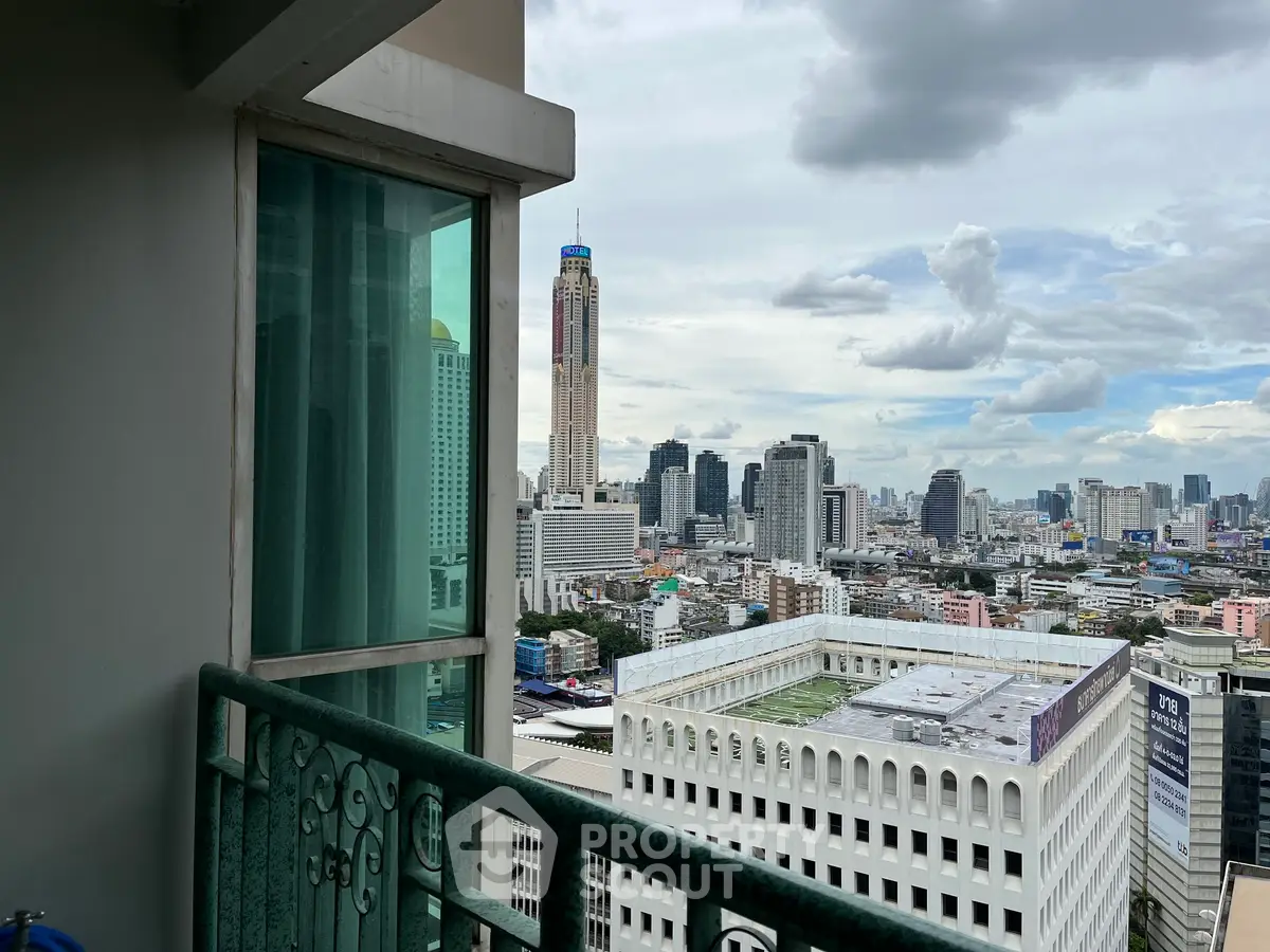 Stunning cityscape view from a high-rise balcony with modern urban skyline.