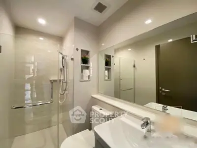 Modern bathroom with sleek fixtures and large mirror