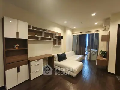 Modern living room with sleek furniture and stylish shelving in a cozy apartment.