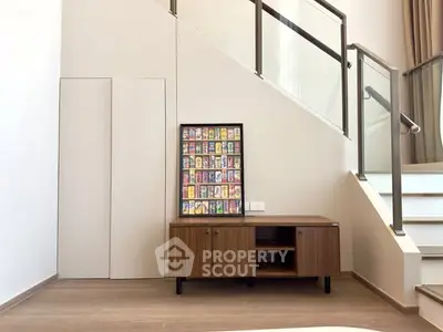 Modern interior with stylish wooden cabinet and staircase, perfect for contemporary living spaces.