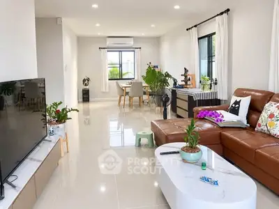 Spacious modern living room with sleek furniture and abundant natural light.