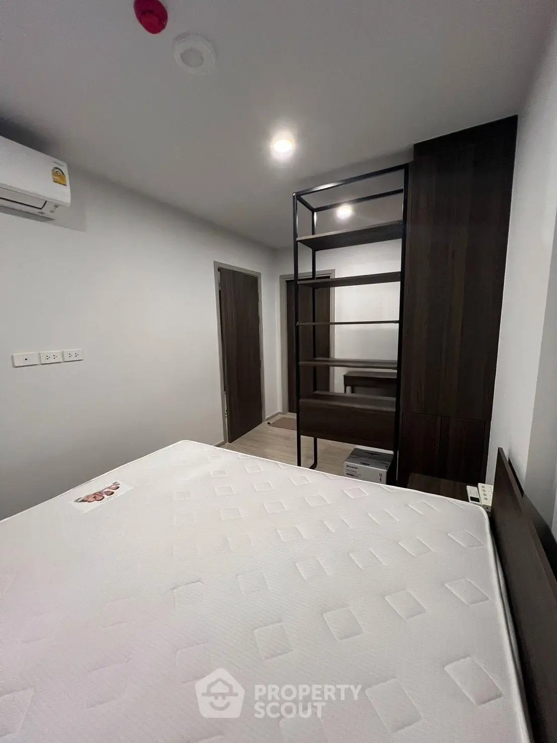 Modern bedroom with minimalist design and built-in storage solutions.