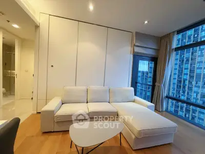 Modern living room with sleek white sofa and city view, perfect for urban living.