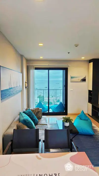 Modern living room with ocean view, stylish decor, and balcony access