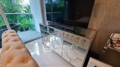 Stylish living room with mirrored console and balcony view, perfect for modern living.