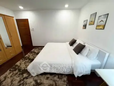 Spacious bedroom with cozy bed and elegant decor in modern home