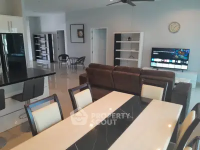 Spacious modern living room with dining area and sleek kitchen design