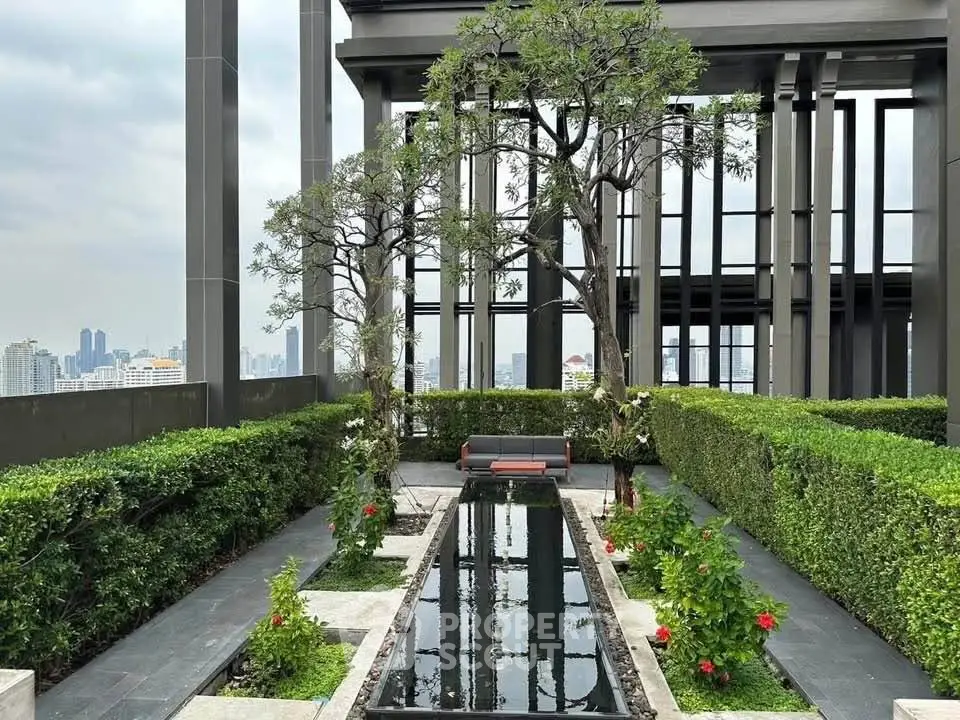 Luxurious rooftop garden with stunning city views and serene water feature.