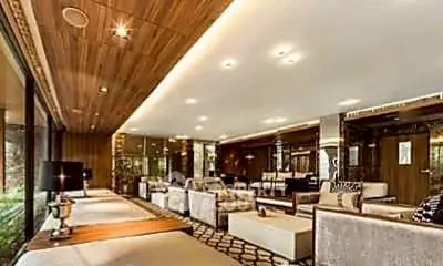 Luxurious and spacious living room with modern decor and ample natural light.