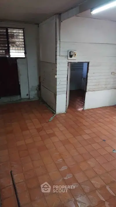 Spacious interior with tiled flooring and natural light, ideal for versatile use.