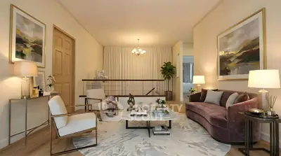 Elegant living room with modern furniture and stylish decor, featuring a plush sofa and contemporary artwork.