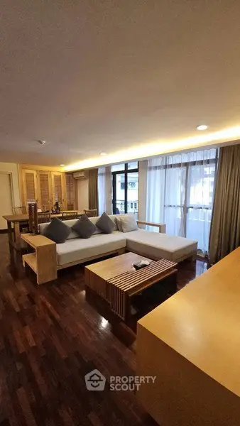 Spacious living room with modern furniture and large windows for natural light