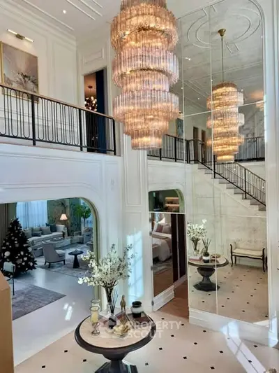 Luxurious two-story living room with grand chandelier and elegant decor