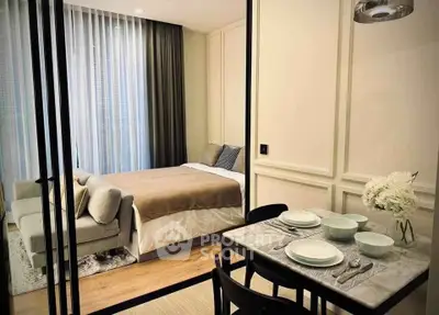 Modern studio apartment with cozy bedroom and dining area, featuring elegant decor and natural light.