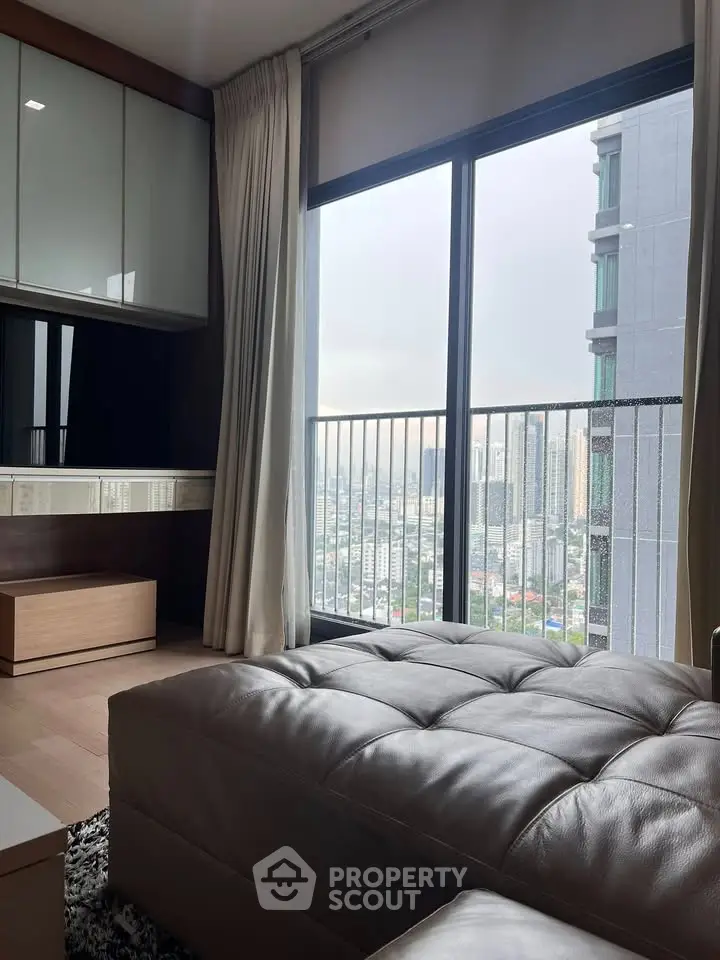Luxurious living room with stunning city view from high-rise apartment balcony.