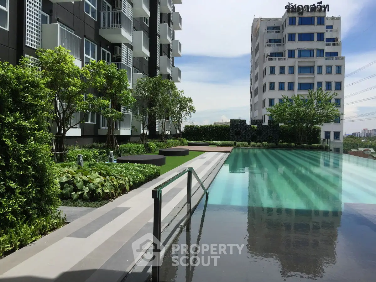 Luxurious apartment complex with stunning pool and lush garden view