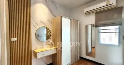 Modern bedroom with stylish decor and air conditioning unit