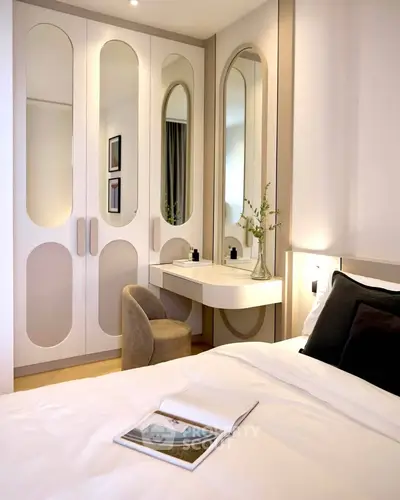 Elegant bedroom with stylish wardrobe and cozy reading nook, perfect for modern living.