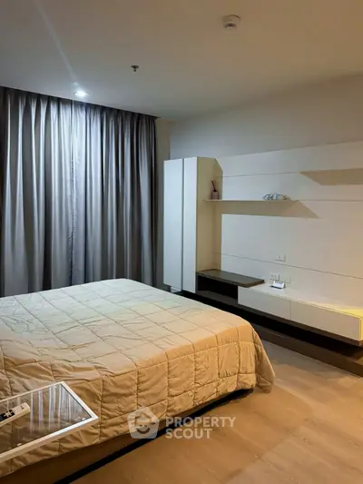 Modern bedroom with stylish decor and cozy ambiance, featuring a comfortable bed and sleek furniture.