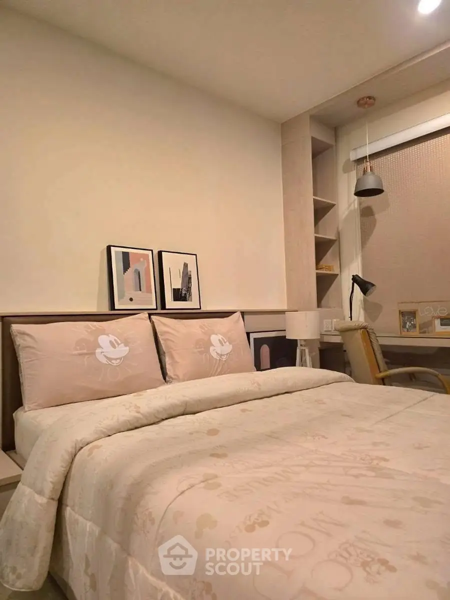 Cozy bedroom with stylish decor and built-in desk, perfect for modern living.