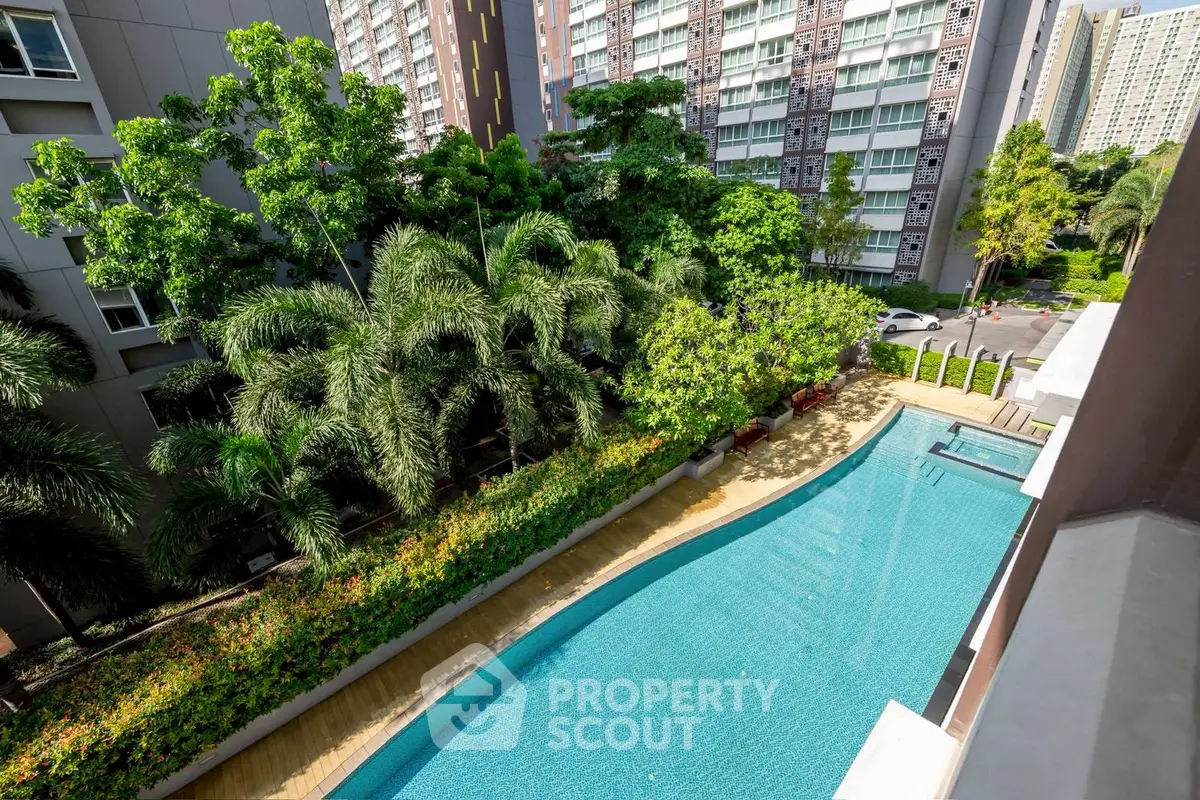 Luxurious condo with stunning pool view and lush greenery