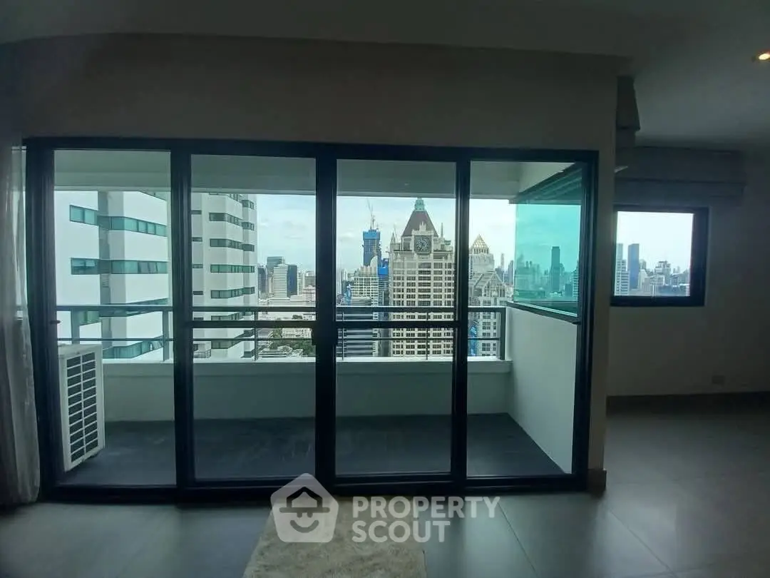 Spacious apartment with stunning city view and large balcony in modern high-rise building.