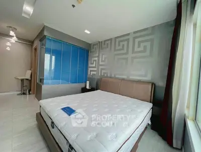 Modern bedroom with stylish decor and large window offering natural light.